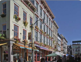 Green and Blue Building with Flowers at Each Window
