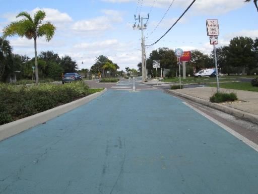 Photo of a green, paved bike trail.