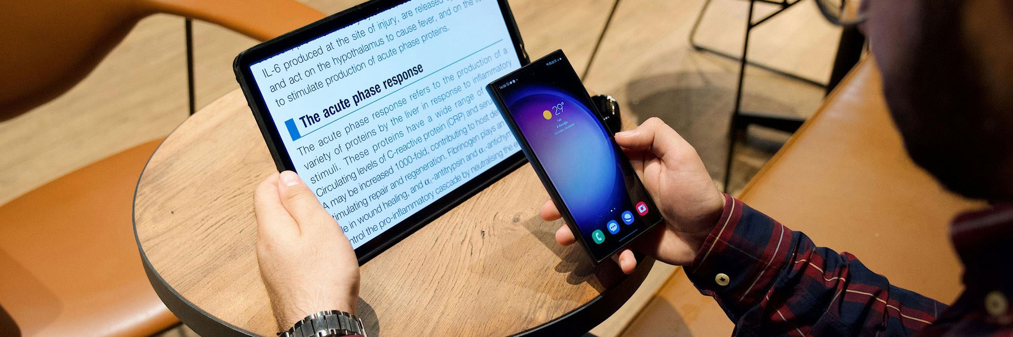 man reading on tablet with phone