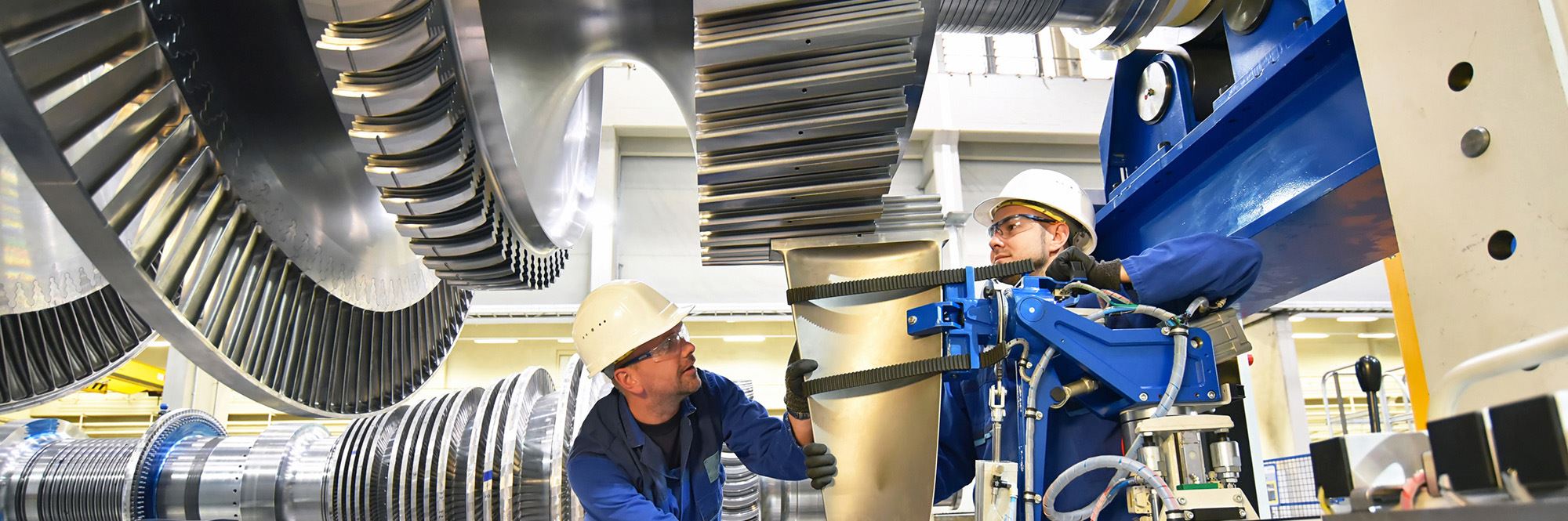 men assembling jet rotor