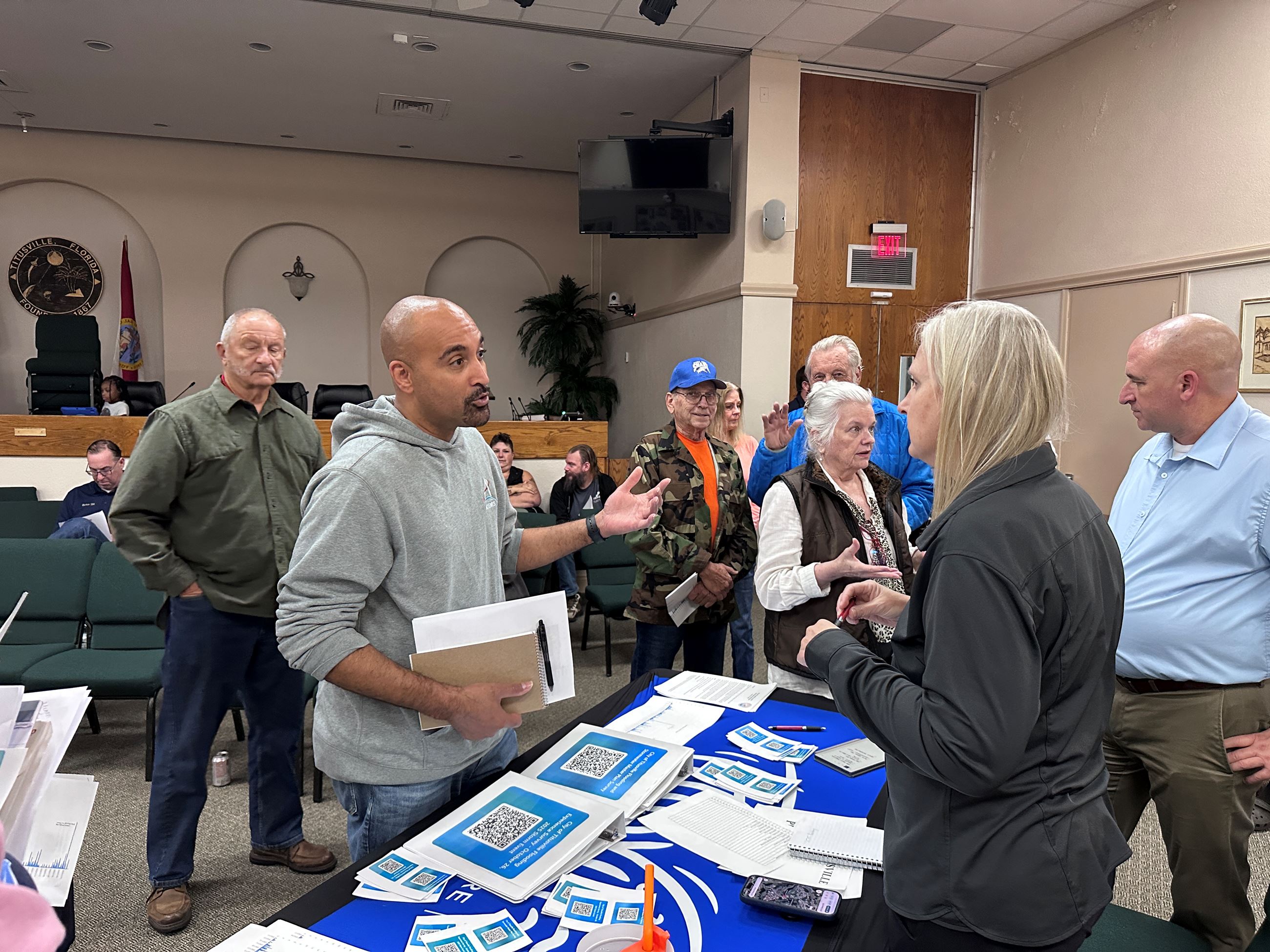 A citizen speaks with Interim Public Works Director Sandy Reller at the workshop.